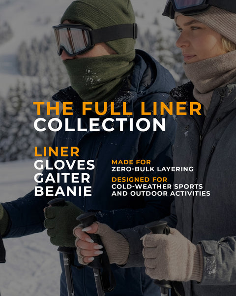 Two people skiing outdoors wearing merino wool liner gloves, gaiters, and beanies, demonstrating the full liner collection designed for zero-bulk layering and cold-weather sports.
