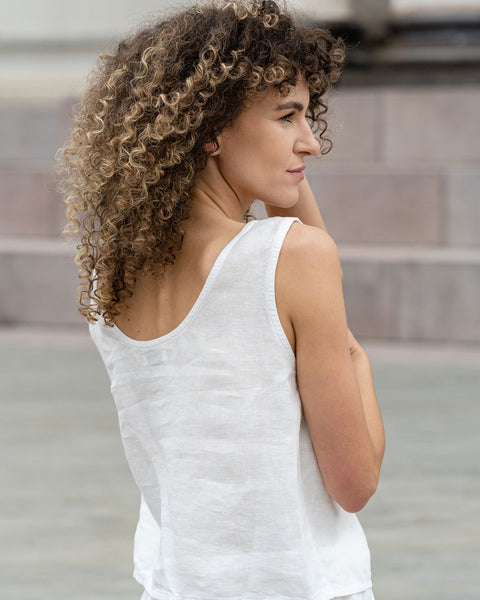 Woman standing outdoor and wearing Linen Sleeveless Crop Top Ana in Pure White color