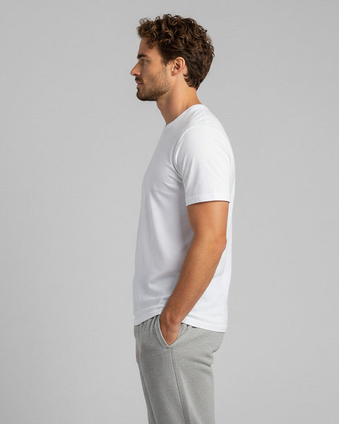 Side view of man wearing a white bamboo t-shirt and gray joggers, casual look.