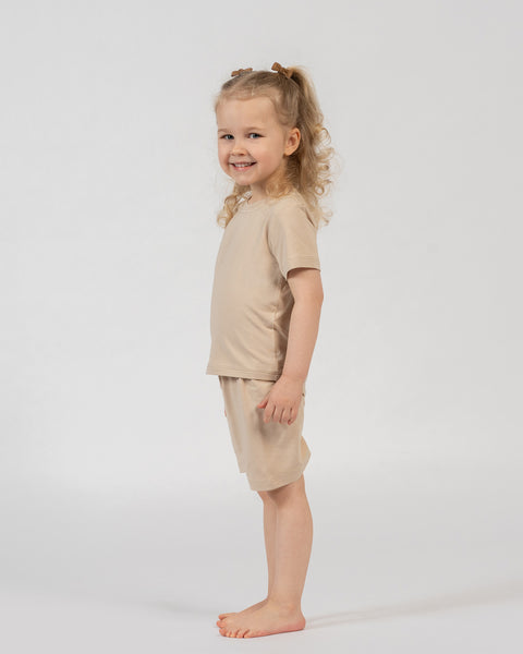 Kids bamboo t-shirt and shorts set in beige, soft neutral outfit for all-day comfort.