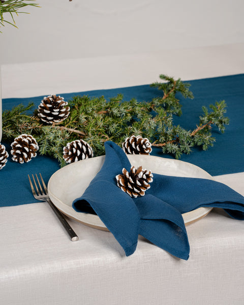 Christmas holiday table with cobalt blue linen napkins.