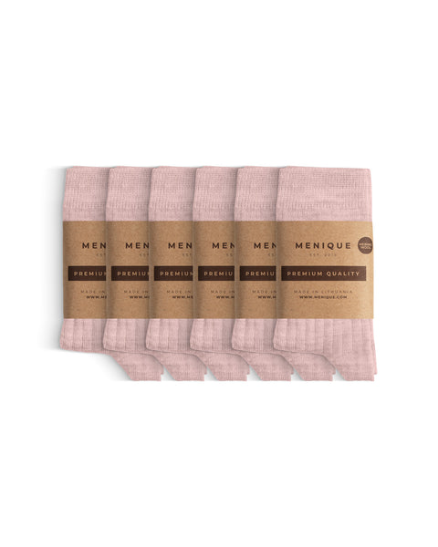 Six pairs of thin ribbed kids’ socks in soft pink, neatly folded and wrapped with Menique brown paper labels that read ‘Premium Quality.