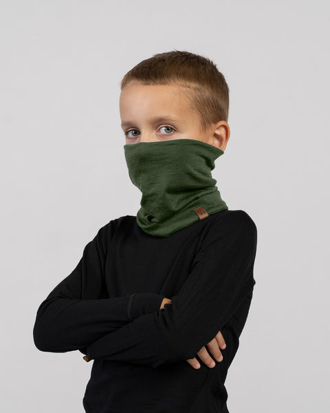 Child wearing a dark green Merino wool neck gaiter pulled up over face – breathable and comfortable neck warmer for cold days.