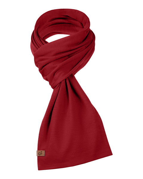 Unisex red Merino wool scarf folded in a stylish knot, with small logo tag.