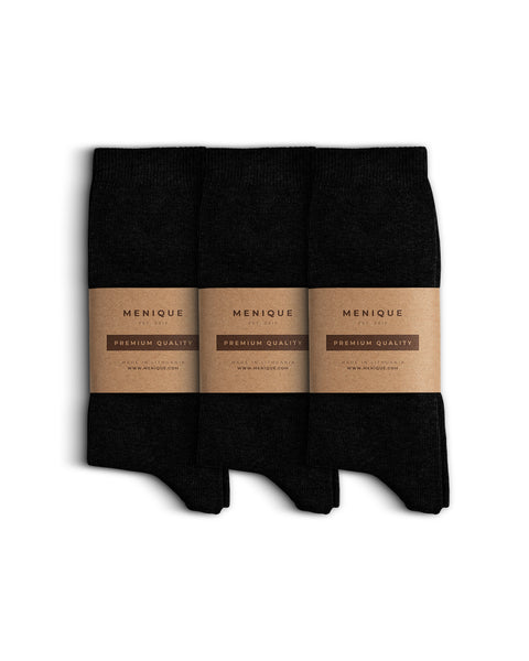 Set of three pairs of cotton socks, neatly folded and wrapped with Menique’s minimalist brown kraft paper packaging labeled ‘Premium Quality.